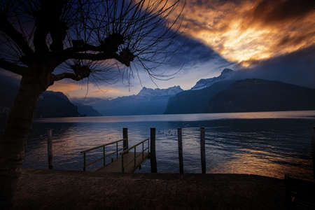 dramatic reflection in the sky and clouds during sunset at lake Lucerne in Switzerlandの写真素材