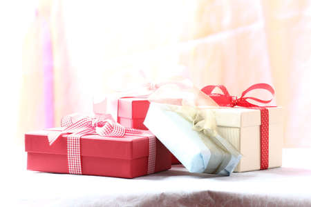 Presents on a table with a bow. Background space for copy. For Christmas, birthday or other holiday cardsの写真素材
