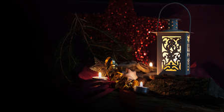 christmas backgrounds with low key lighting with candles and lanternの写真素材