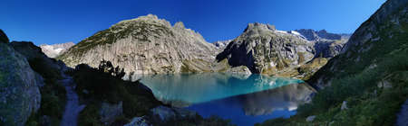 Gelmersee. Dam in the Swiss Alps for Hydro power. Clear blue lake with clear sky.の写真素材