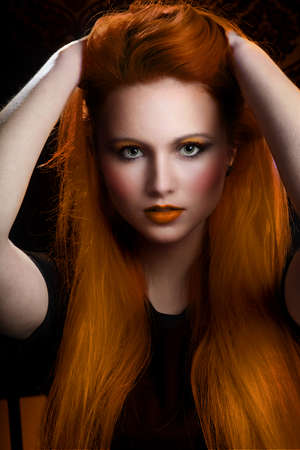 pretty girl with very long orange hair and green eyes. heavy makeup and clean face. Model with pretty faceの写真素材