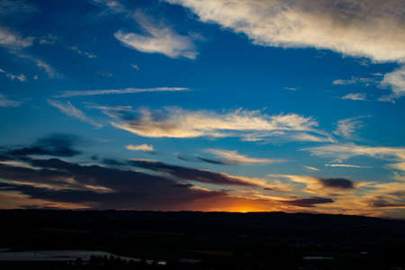 colorful sky with sun in high cloudsの写真素材