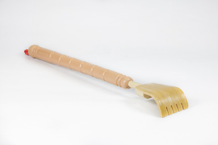 wooden backscratcher on a white background.の写真素材