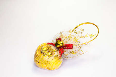Gold heart on a white background.の写真素材