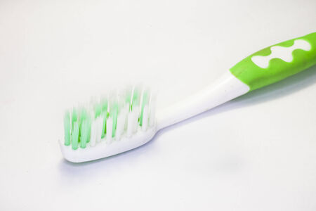 Green and White Toothbrush On white backgroundの写真素材