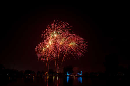 Fireworks of multiples colors on water の写真素材