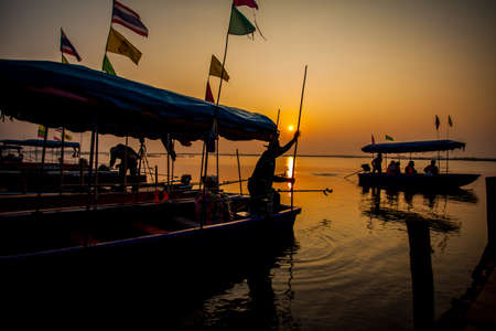 Silhouette of a fisherman on the sunset  の写真素材