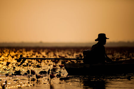 Silhouette of a fisherman on the sunset  の写真素材