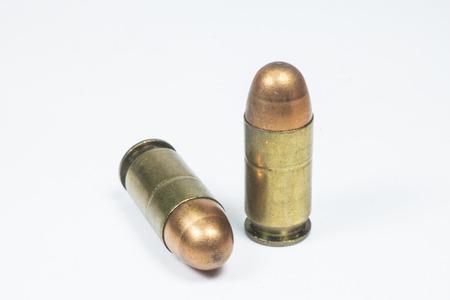 11 mm  Black handgun And ammunition isolated on whiteの写真素材