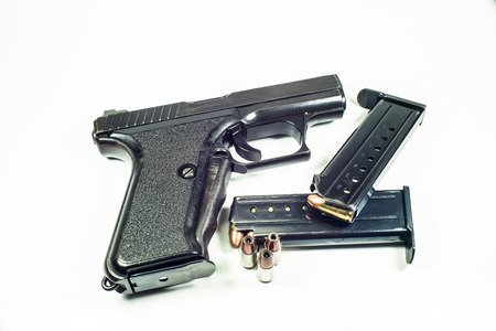 9 mm handgun in a leather holster isolated on white 
