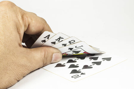 royal flush playing cards in hand On white background