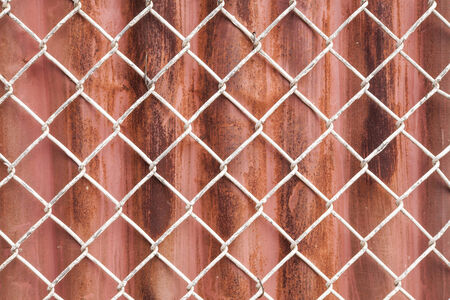 Wire Mesh and red corrugated fence  backgroundの写真素材
