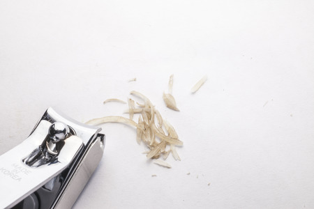 manicure with nail clipper on white background