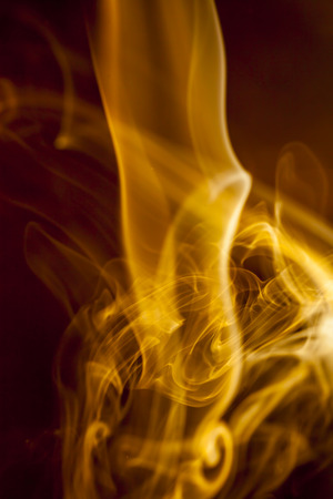 Gold smoke  on black backgroundの写真素材
