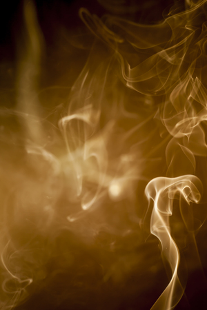 Gold  smoke on black backgroundの写真素材