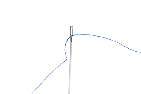 needle and thread close up on a white backgroundの写真素材