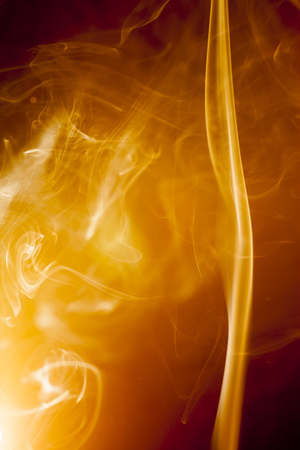 Golden smoke on black backgroundの写真素材