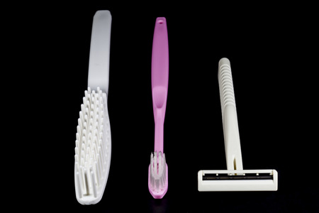 Toothbrush,comb,shaving razor on a black background の写真素材