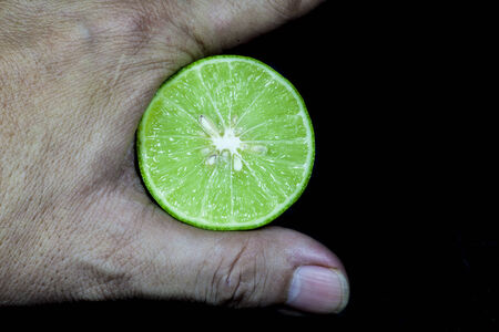 Fresh limes on a black background.の写真素材