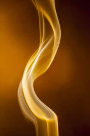 Gold smoke  on black backgroundの写真素材
