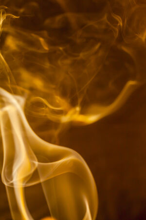 Gold smoke  on black backgroundの写真素材