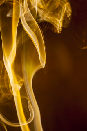 Gold smoke  on black backgroundの写真素材