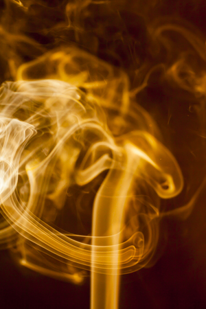 Gold smoke  on black backgroundの写真素材