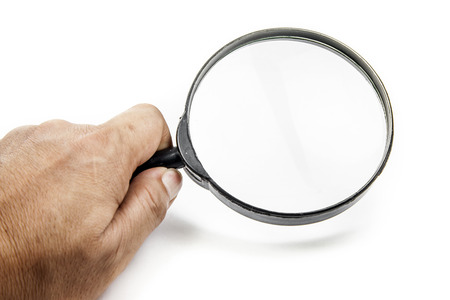 Man's hand, holding classic styled magnifying glassの写真素材