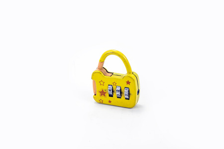 Small yellow padlock On white backgroundの写真素材