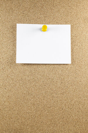 Blank white note papers is pinned to a cork board.の写真素材