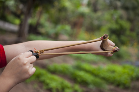 Hand boy pulling sling shot.の写真素材