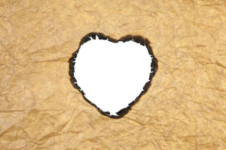 Brown paper burning heart shaped.の写真素材