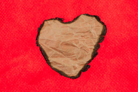 Brown paper burning heart shaped.の写真素材