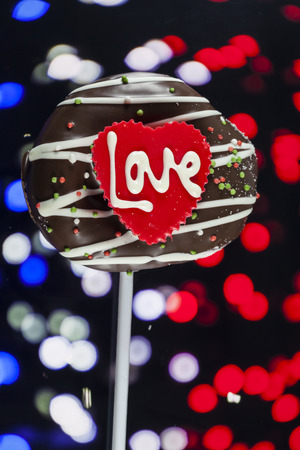 Chocolate of love in heart on bokeh background.の写真素材