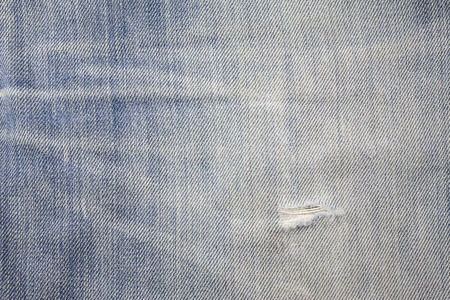 Blue torn denim jeans texture.の写真素材