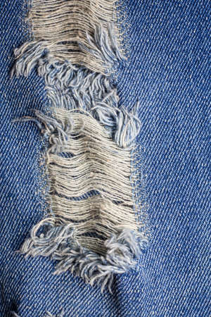 Blue torn denim jeans texture.