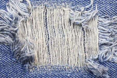 Blue torn denim jeans texture.の写真素材