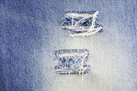 Blue torn denim jeans texture.の写真素材
