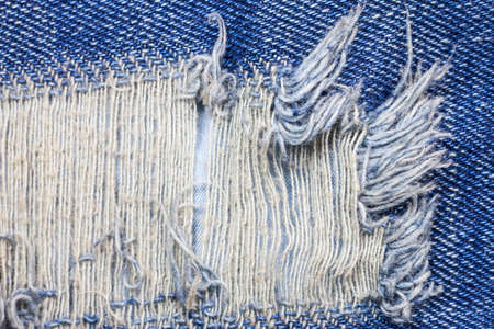 Blue torn denim jeans texture.