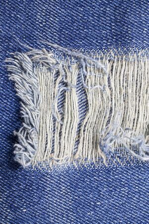 Blue torn denim jeans texture.