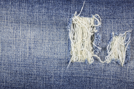 Blue torn denim jeans texture.の写真素材
