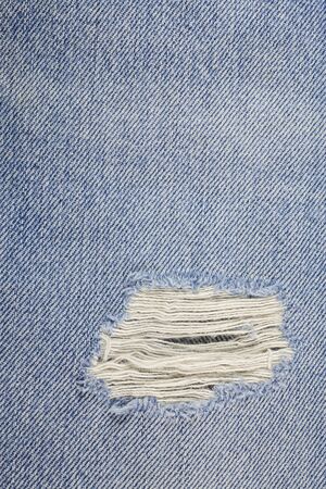 Blue torn denim jeans texture.の写真素材