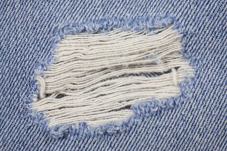 Blue torn denim jeans texture.