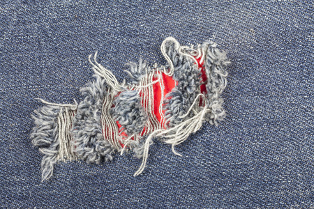 Blue torn denim jeans texture.