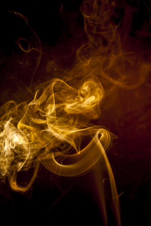 Gold smoke on black backgroundの写真素材