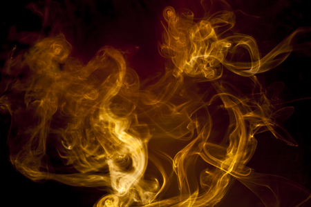 Gold smoke on black backgroundの写真素材