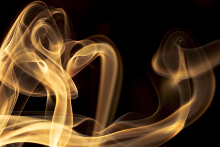 Gold smoke on black background.の写真素材