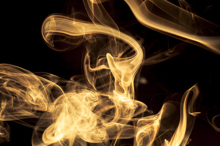 Gold smoke on black background.の写真素材