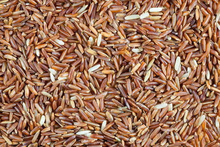 Rice berry on a wooden background.の写真素材