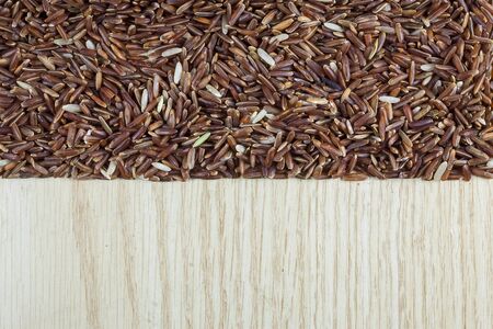 Rice berry on a wooden background.の写真素材